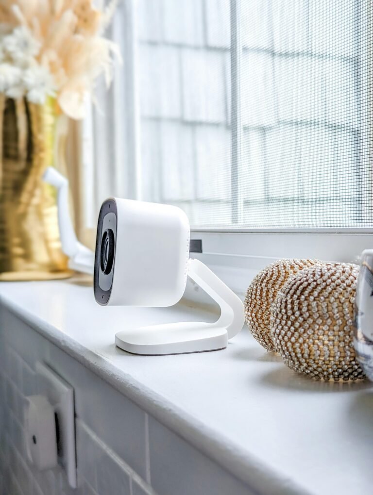 A sleek surveillance camera positioned indoors on a windowsill, capturing elegance.